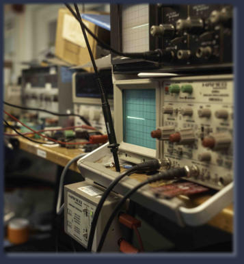 Workbench with circuit boards and diagnostic tools used for industrial electronics repair
