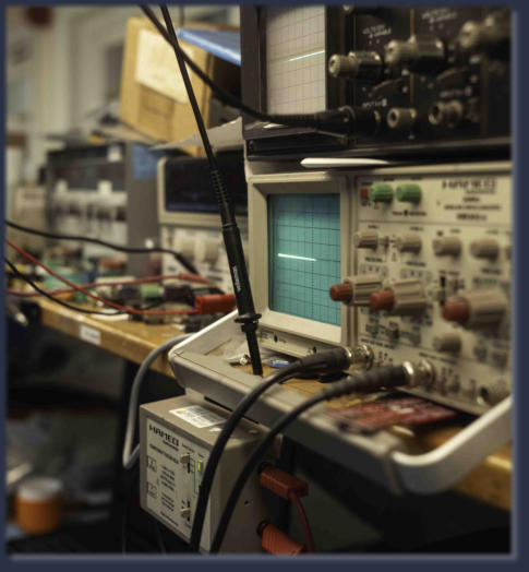 Workbench with circuit boards and diagnostic tools used for industrial electronics repair
